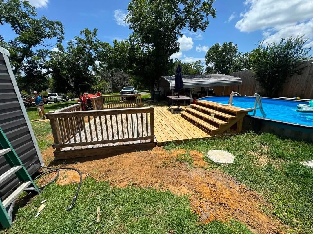Completed wood deck with steps leading to a pool